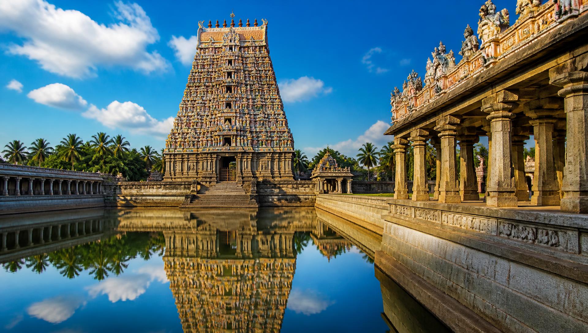 Stunning colourful Kanchipuram temple gopuram reflected in the sacred temple tank, a premium devotional tour destination